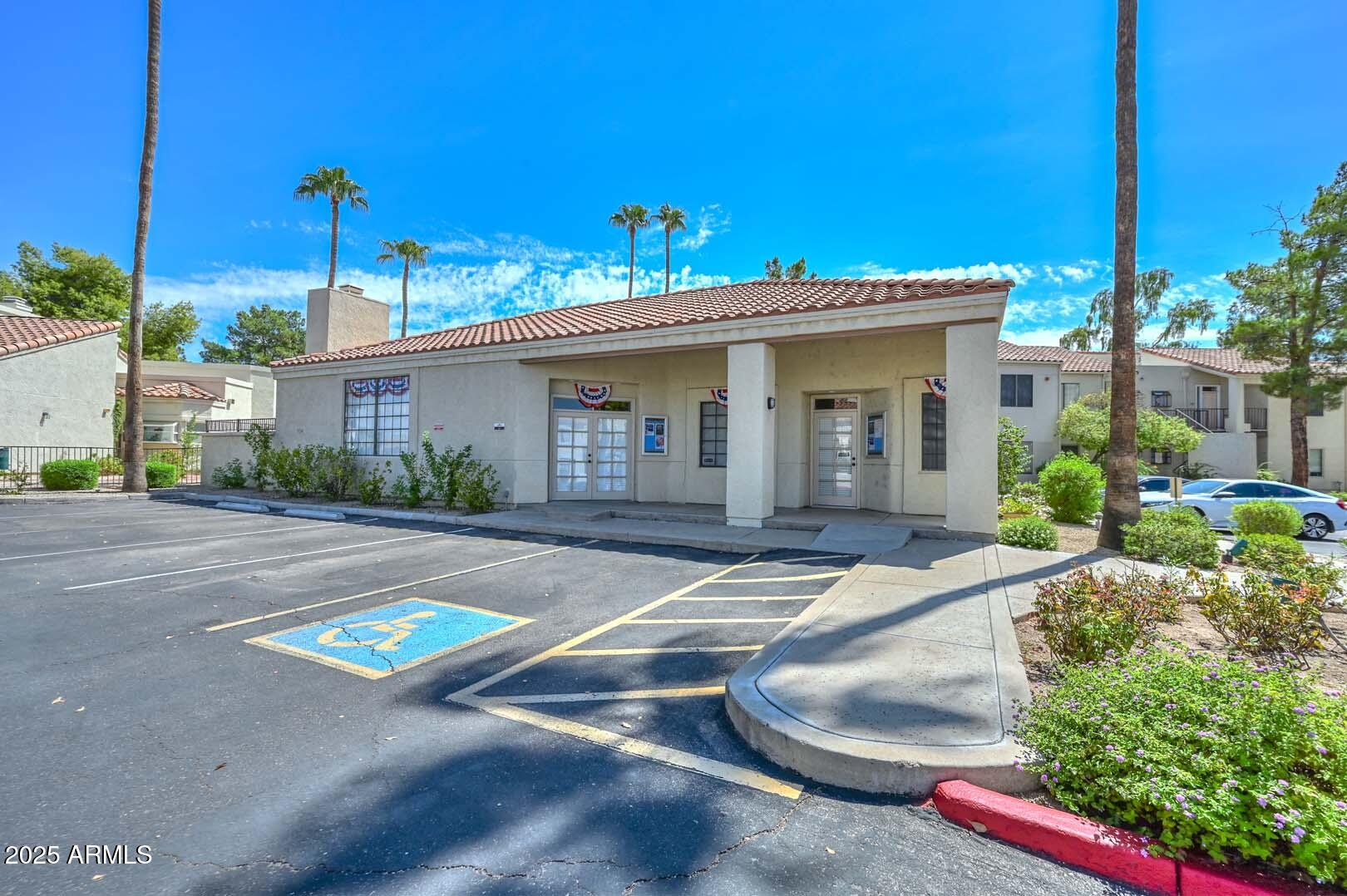 7101 West Beardsley Road, Unit 1104 Glendale, AZ 85308 - Photo 36 of 40 a view of a white house with a yard and plants