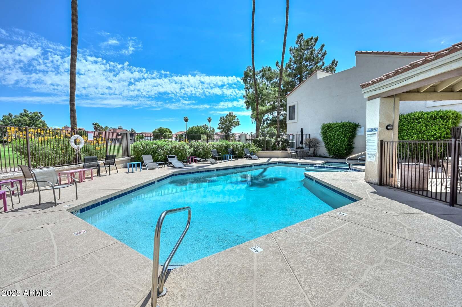 7101 West Beardsley Road, Unit 1104 Glendale, AZ 85308 - Photo 39 of 40 a view of a swimming pool with a lounge chairs