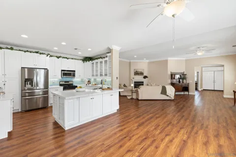 a large white kitchen with stainless steel appliances