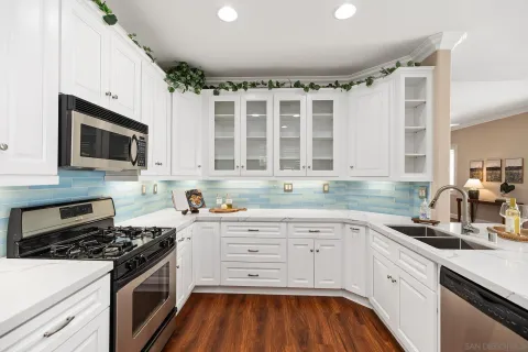 a kitchen with granite countertop a stove and a sink
