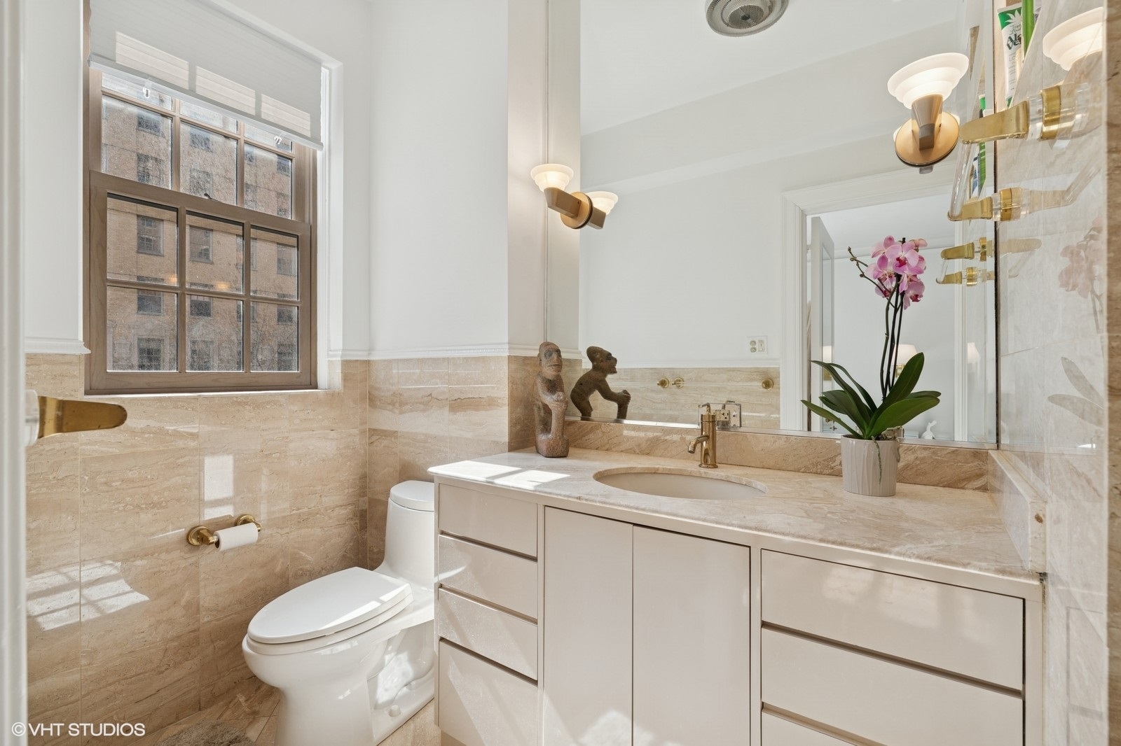 232 East Walton Place, Unit 4E Chicago, IL 60611 - Photo 24 of 32 a bathroom with a granite countertop sink a toilet and a mirror