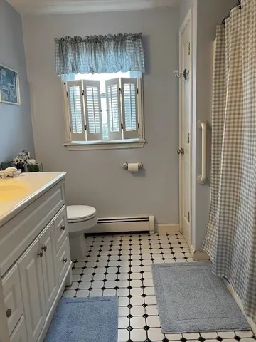 a bathroom with a sink a toilet and a mirror