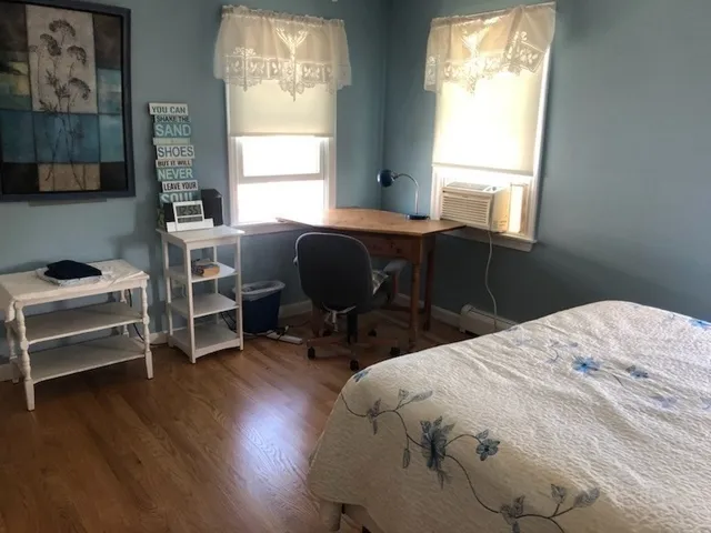 a large bed sitting in a bedroom next to a window