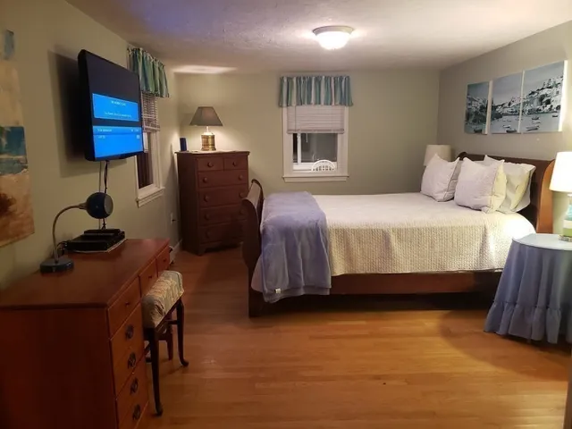 a bathroom with a granite countertop sink mirror vanity and toilet