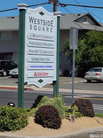 a street view with tall buildings and a street sign