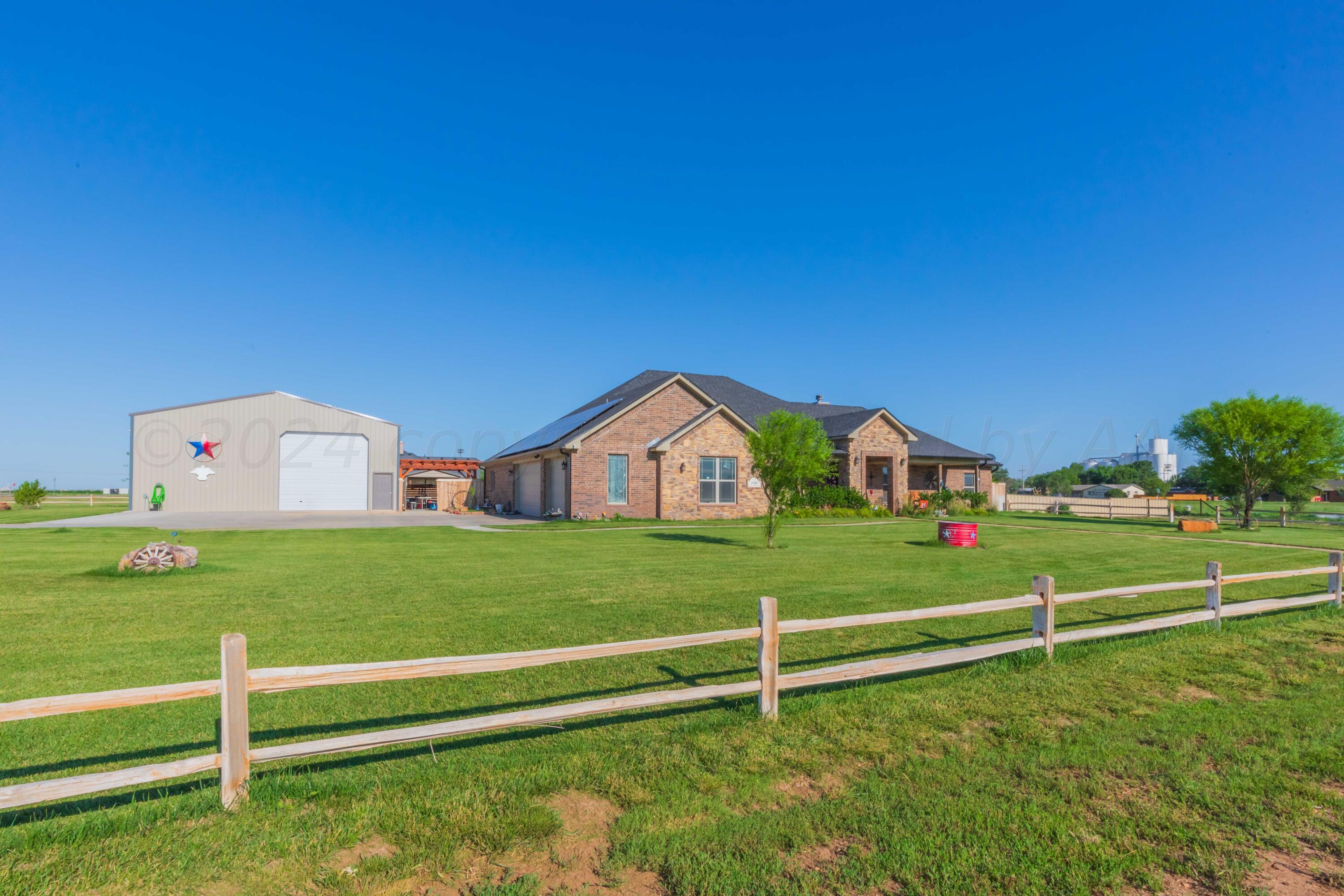 2450 Blue Springs Amarillo, TX 79124 - Photo 1 of 51 a front view of a house with a yard