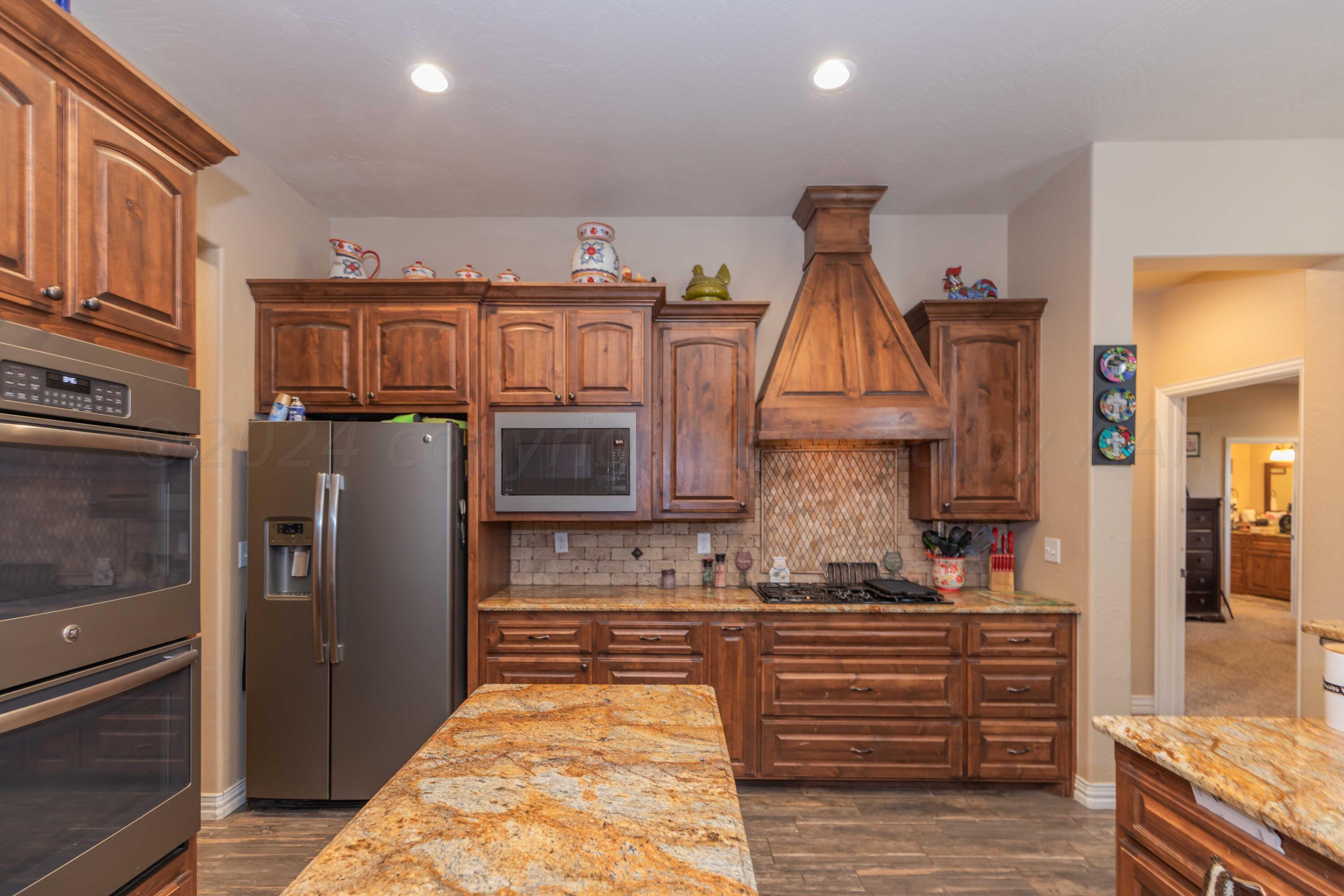 2450 Blue Springs Amarillo, TX 79124 - Photo 11 of 51 a kitchen with stainless steel appliances granite countertop a refrigerator and stove