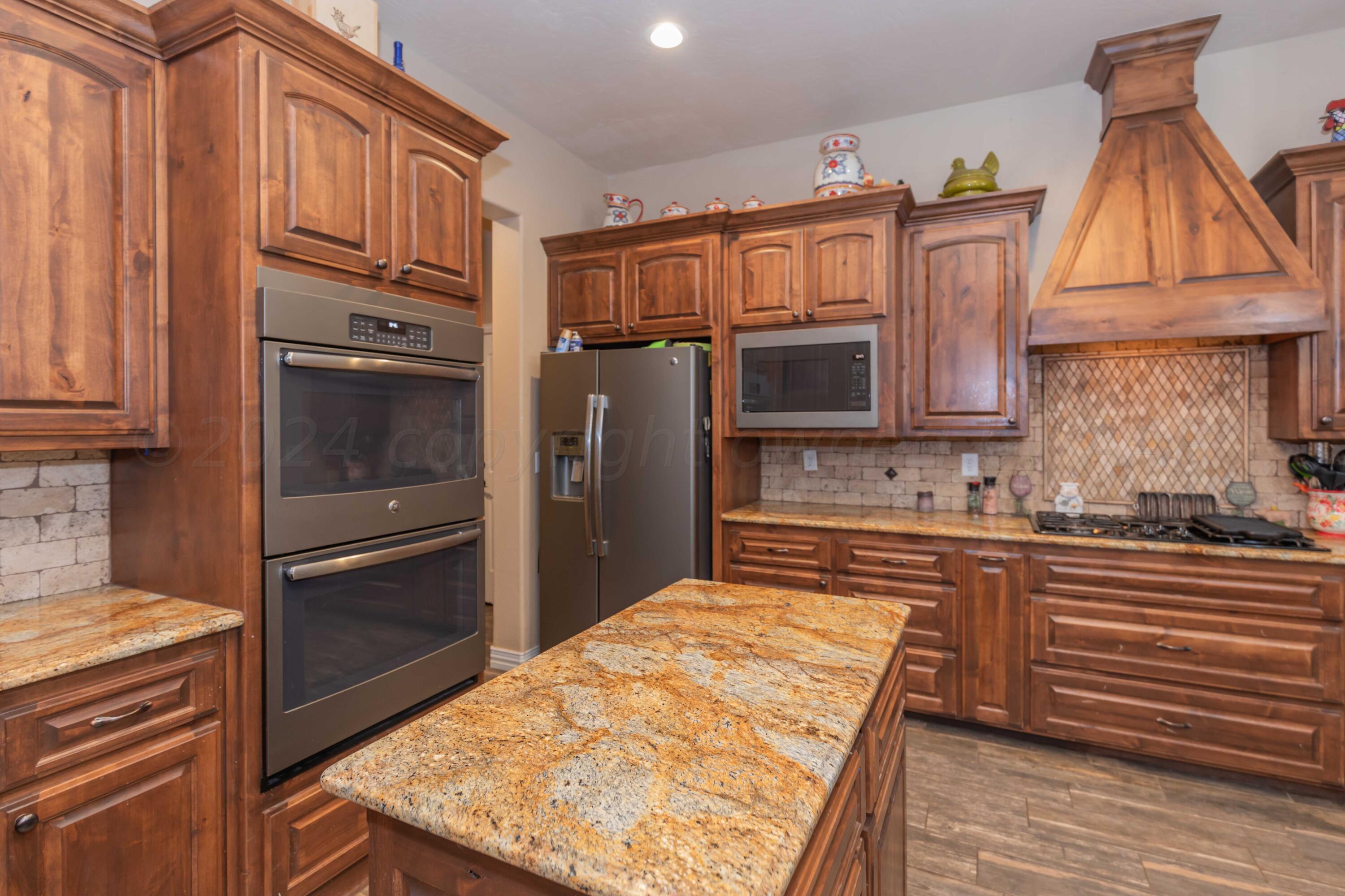 2450 Blue Springs Amarillo, TX 79124 - Photo 12 of 51 a kitchen with stainless steel appliances granite countertop a refrigerator and a stove top oven