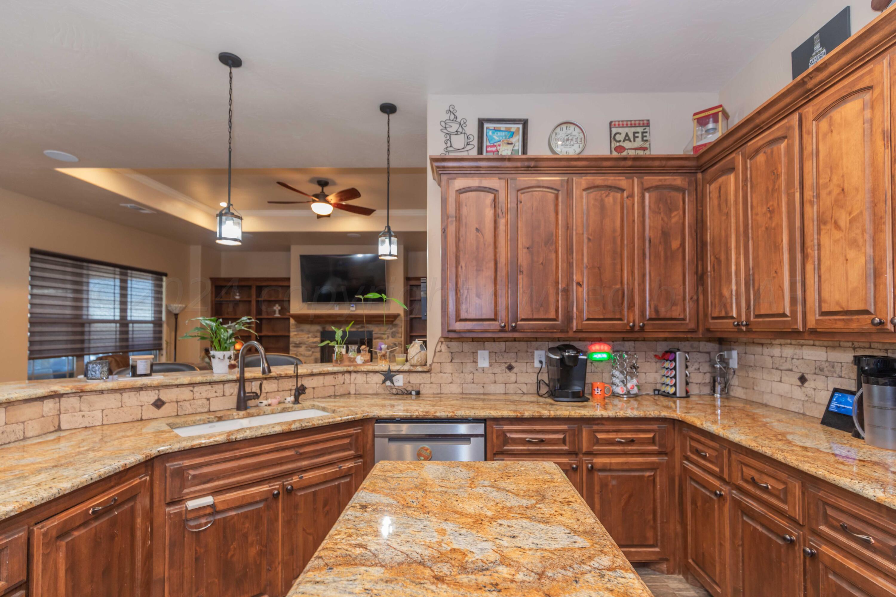 2450 Blue Springs Amarillo, TX 79124 - Photo 14 of 51 a kitchen with kitchen island granite countertop a sink window and stainless steel appliances