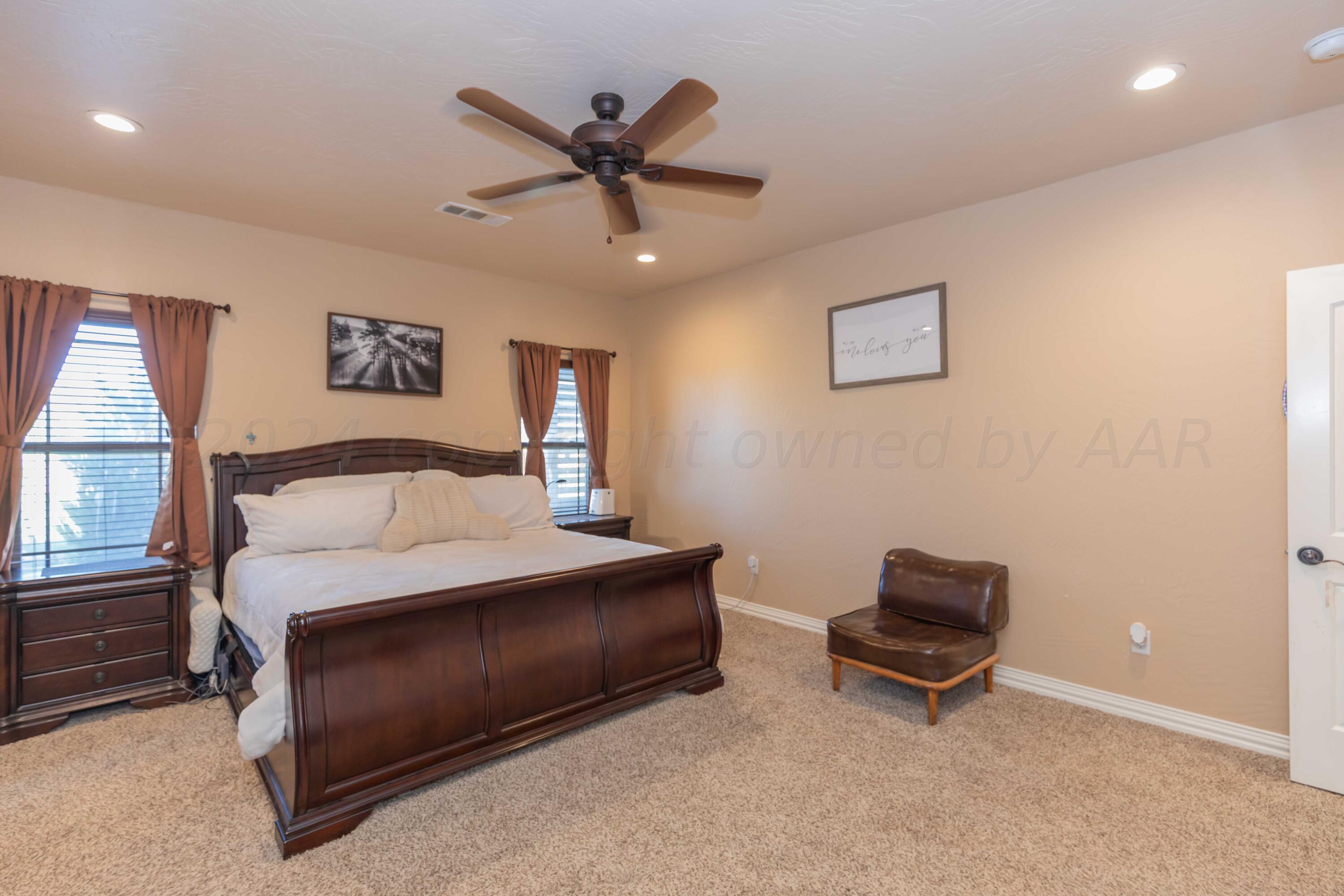 2450 Blue Springs Amarillo, TX 79124 - Photo 18 of 51 a bedroom with a bed and a chandelier