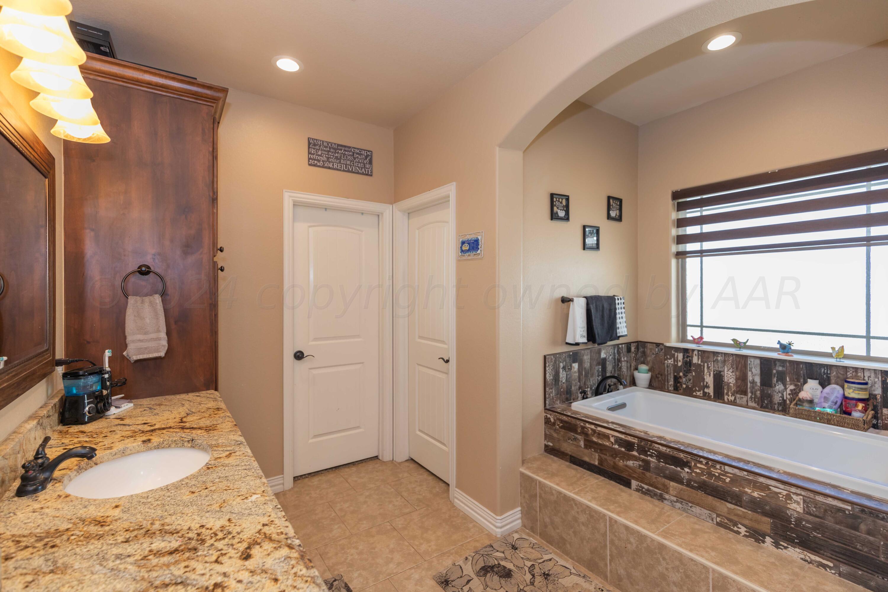 2450 Blue Springs Amarillo, TX 79124 - Photo 21 of 51 a bathroom with bathtub a shower and a sink