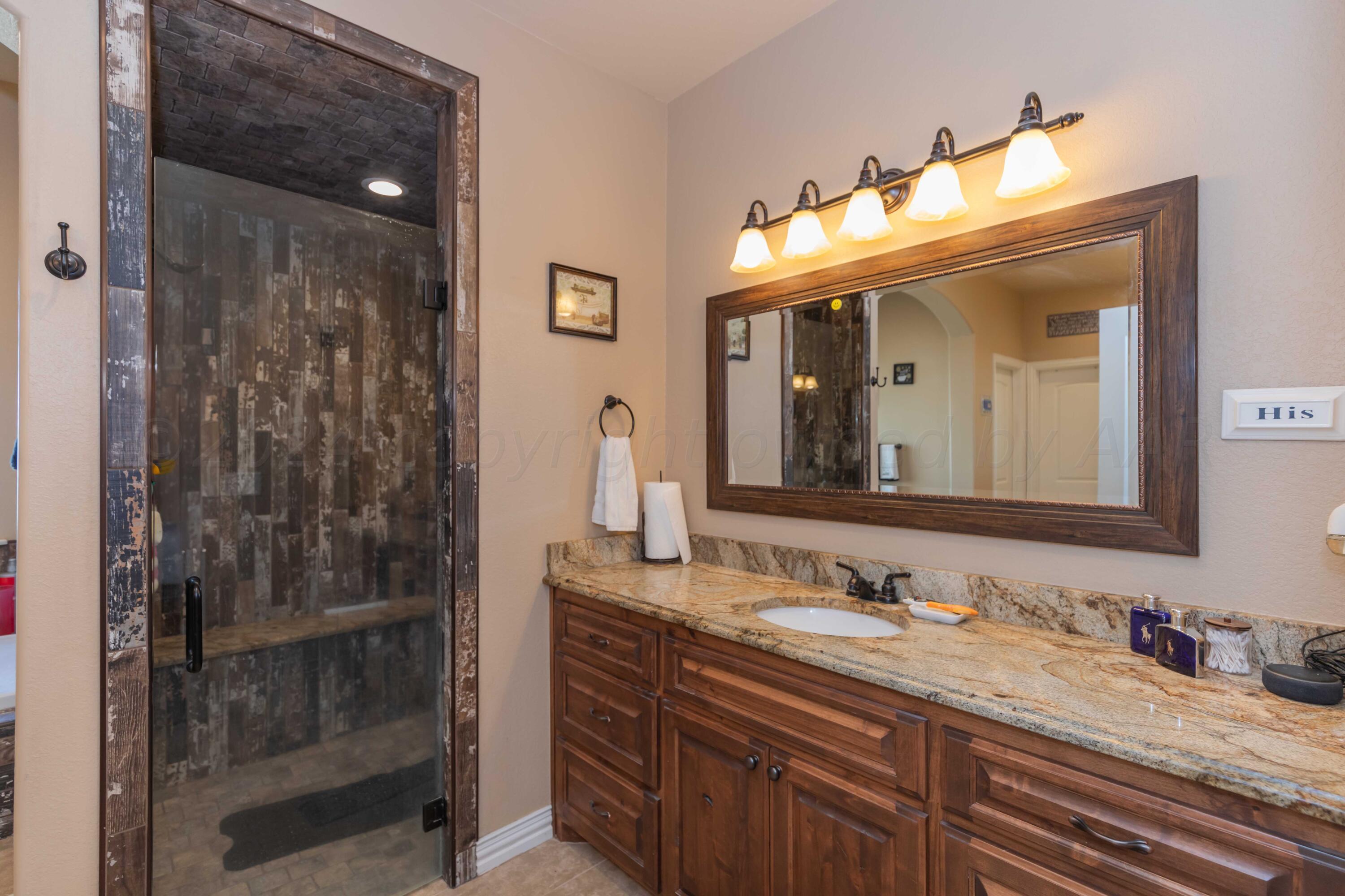 2450 Blue Springs Amarillo, TX 79124 - Photo 23 of 51 a bathroom with a sink and a mirror