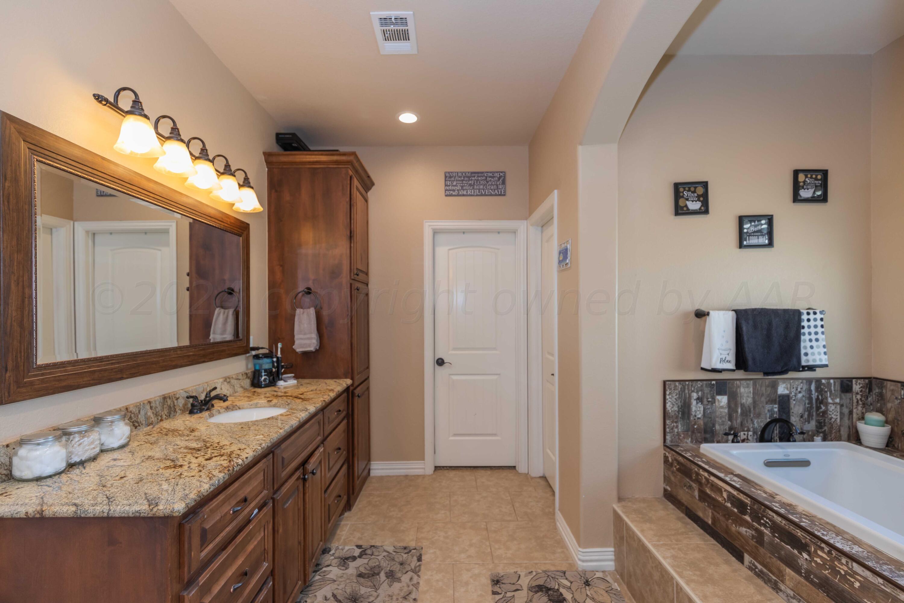 2450 Blue Springs Amarillo, TX 79124 - Photo 24 of 51 a bathroom with a granite countertop double vanity sink and a mirror