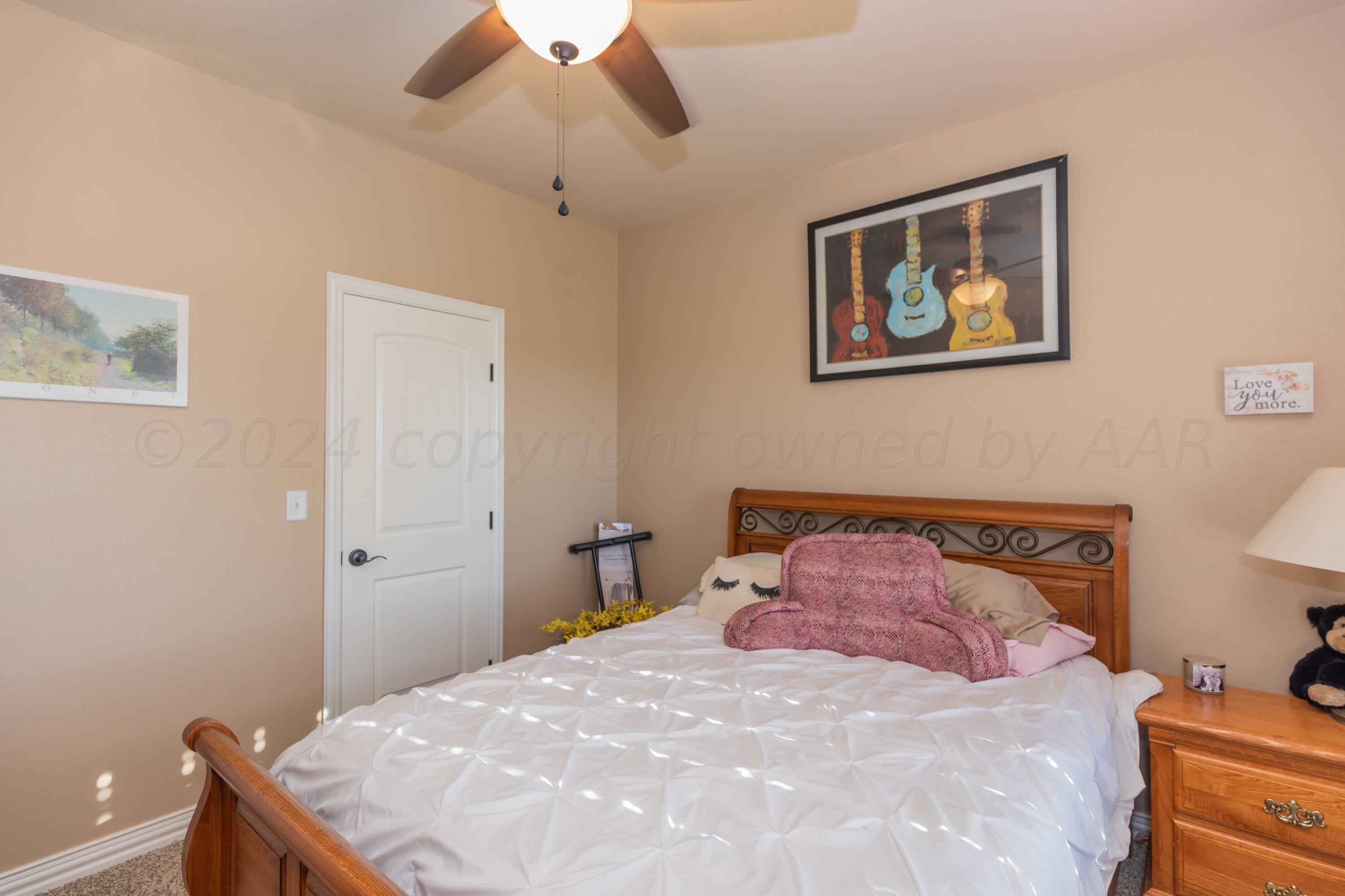 2450 Blue Springs Amarillo, TX 79124 - Photo 25 of 51 a bedroom with a bed and a chandelier