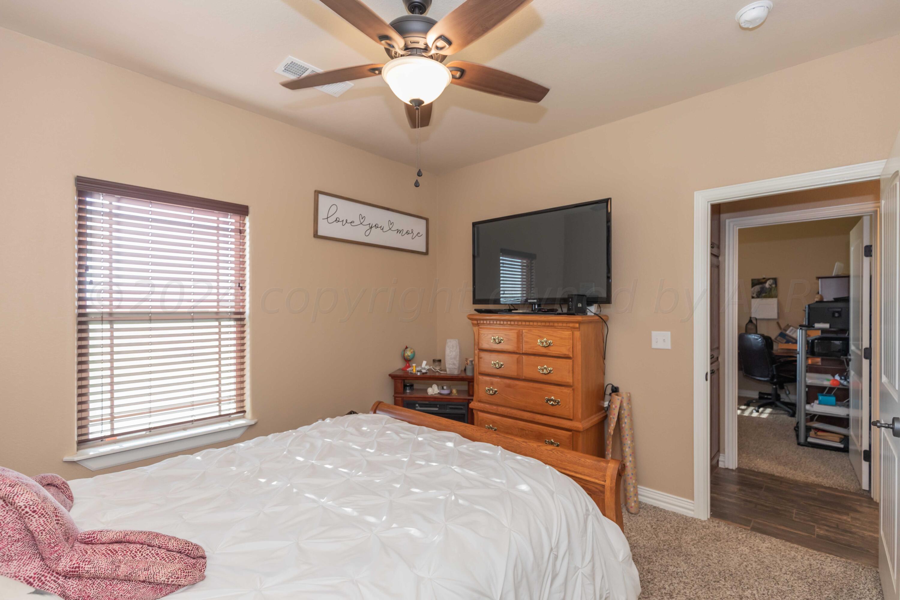 2450 Blue Springs Amarillo, TX 79124 - Photo 26 of 51 a bedroom with a bed and a flat screen tv