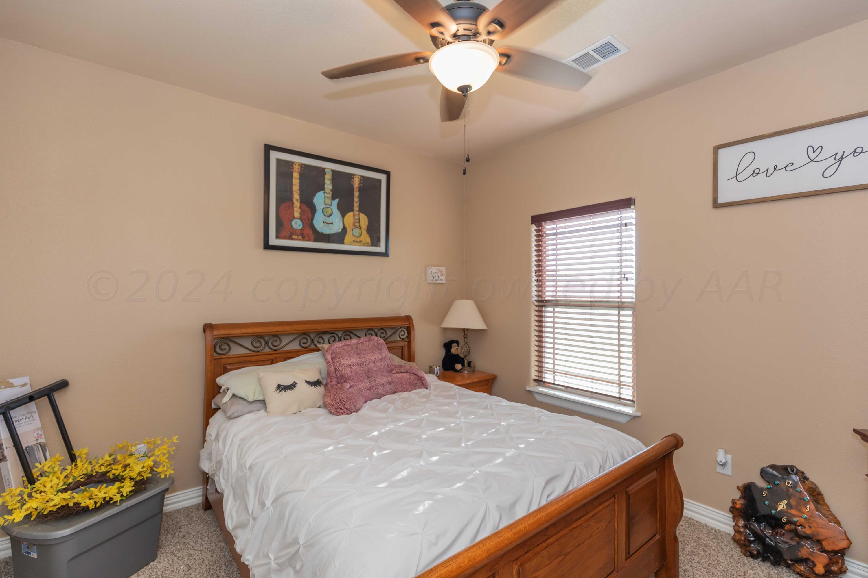2450 Blue Springs Amarillo, TX 79124 - Photo 29 of 51 a bedroom with a bed and a window