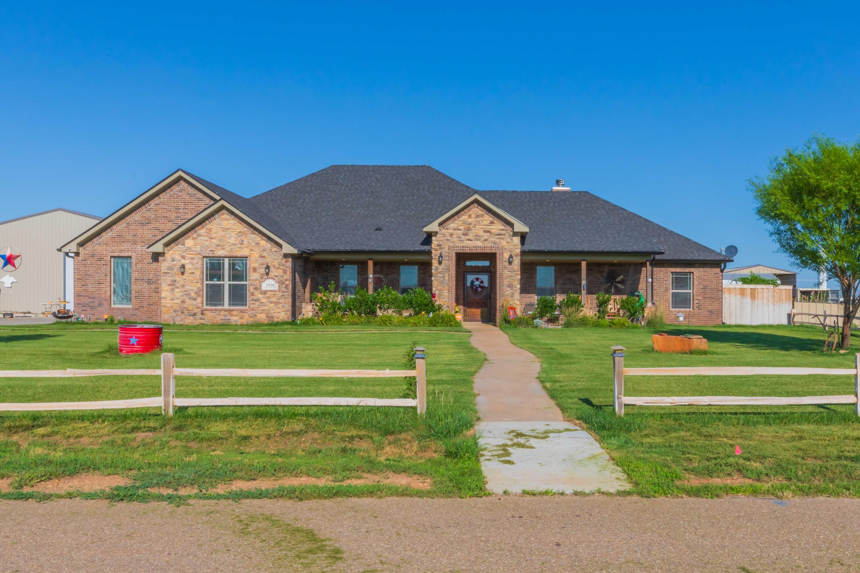 2450 Blue Springs Amarillo, TX 79124 - Photo 3 of 51 a front view of a house with a yard and trees