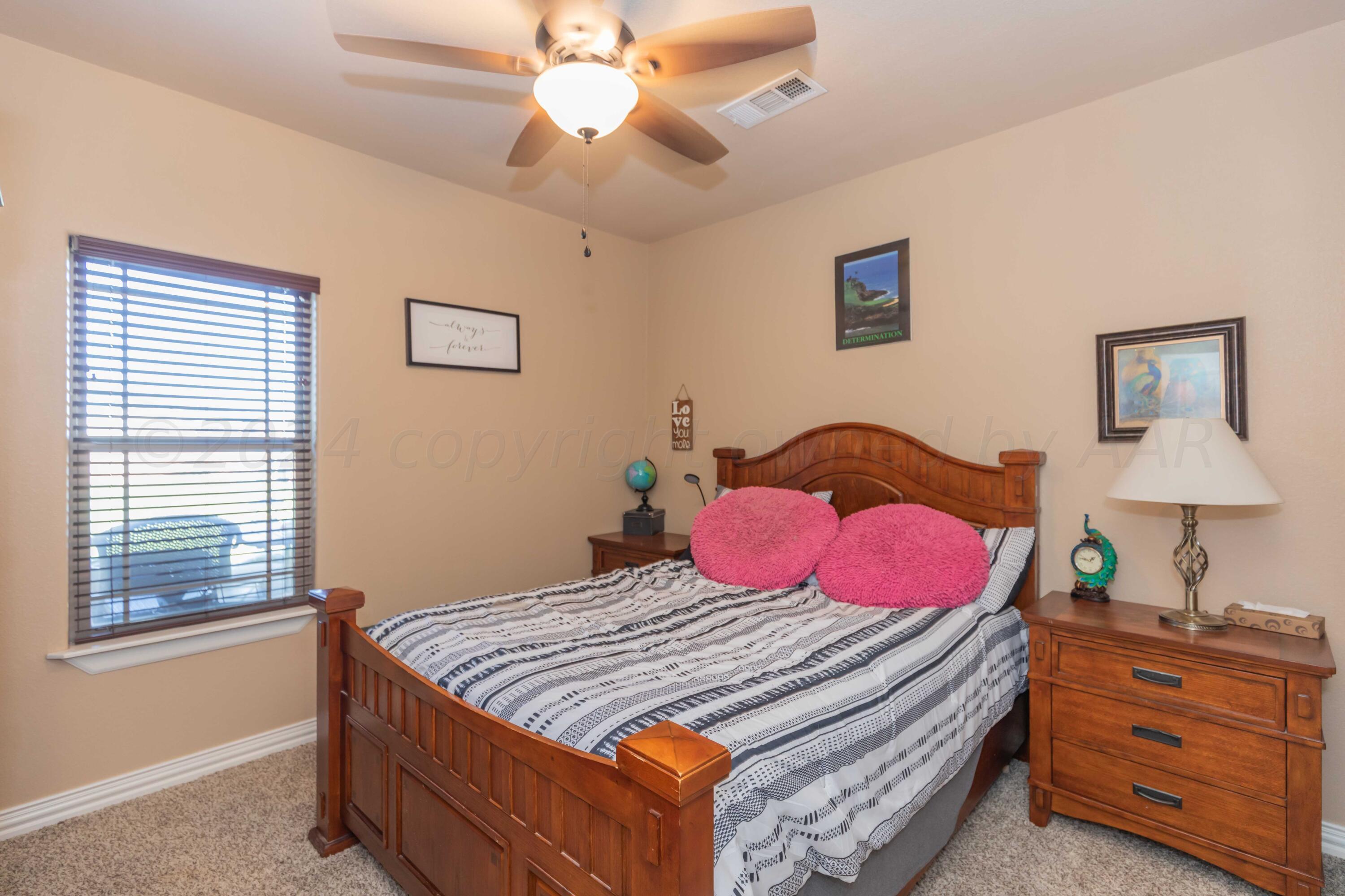 2450 Blue Springs Amarillo, TX 79124 - Photo 31 of 51 a bedroom with a bed and a chandelier