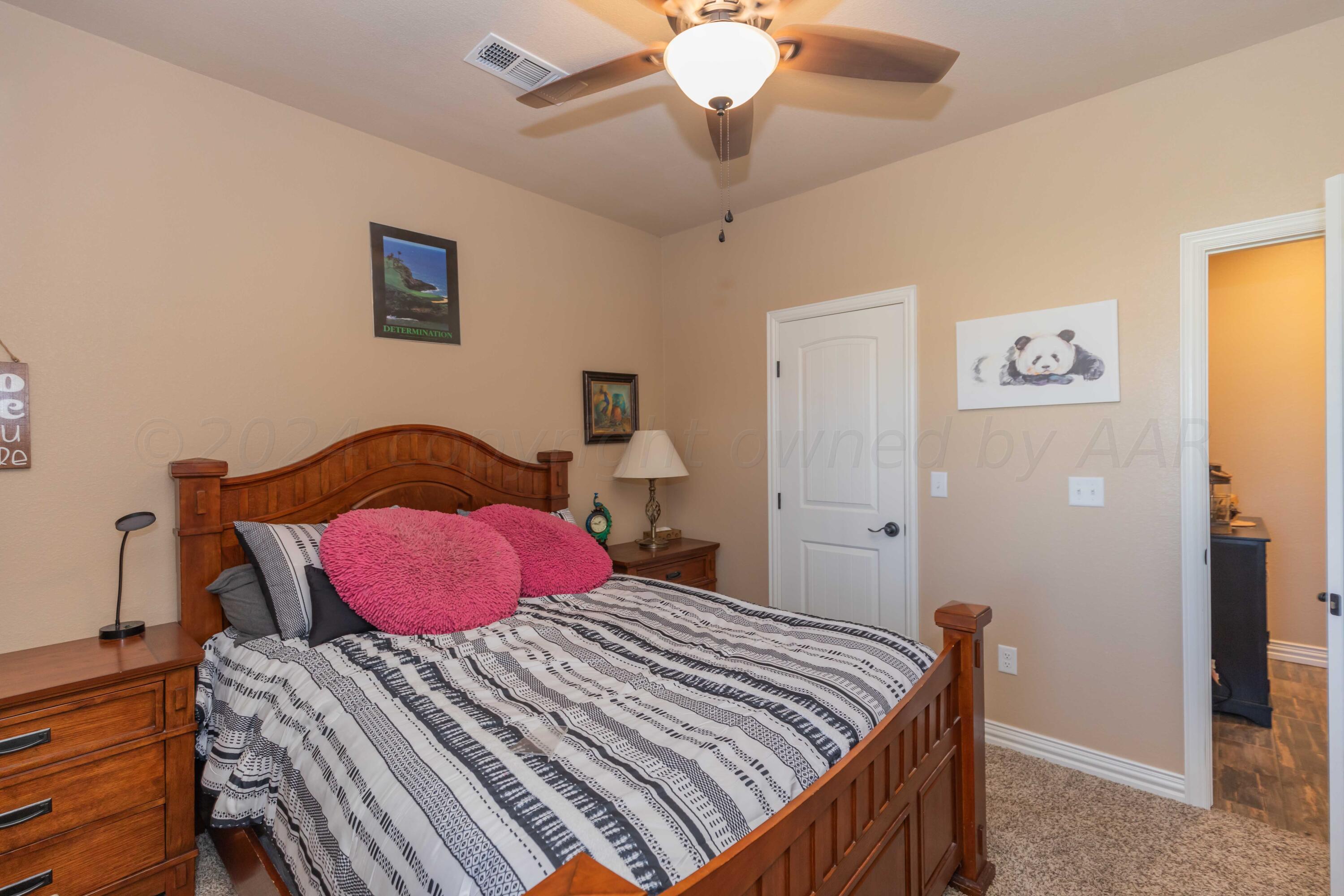 2450 Blue Springs Amarillo, TX 79124 - Photo 33 of 51 a bedroom with a bed and a chandelier