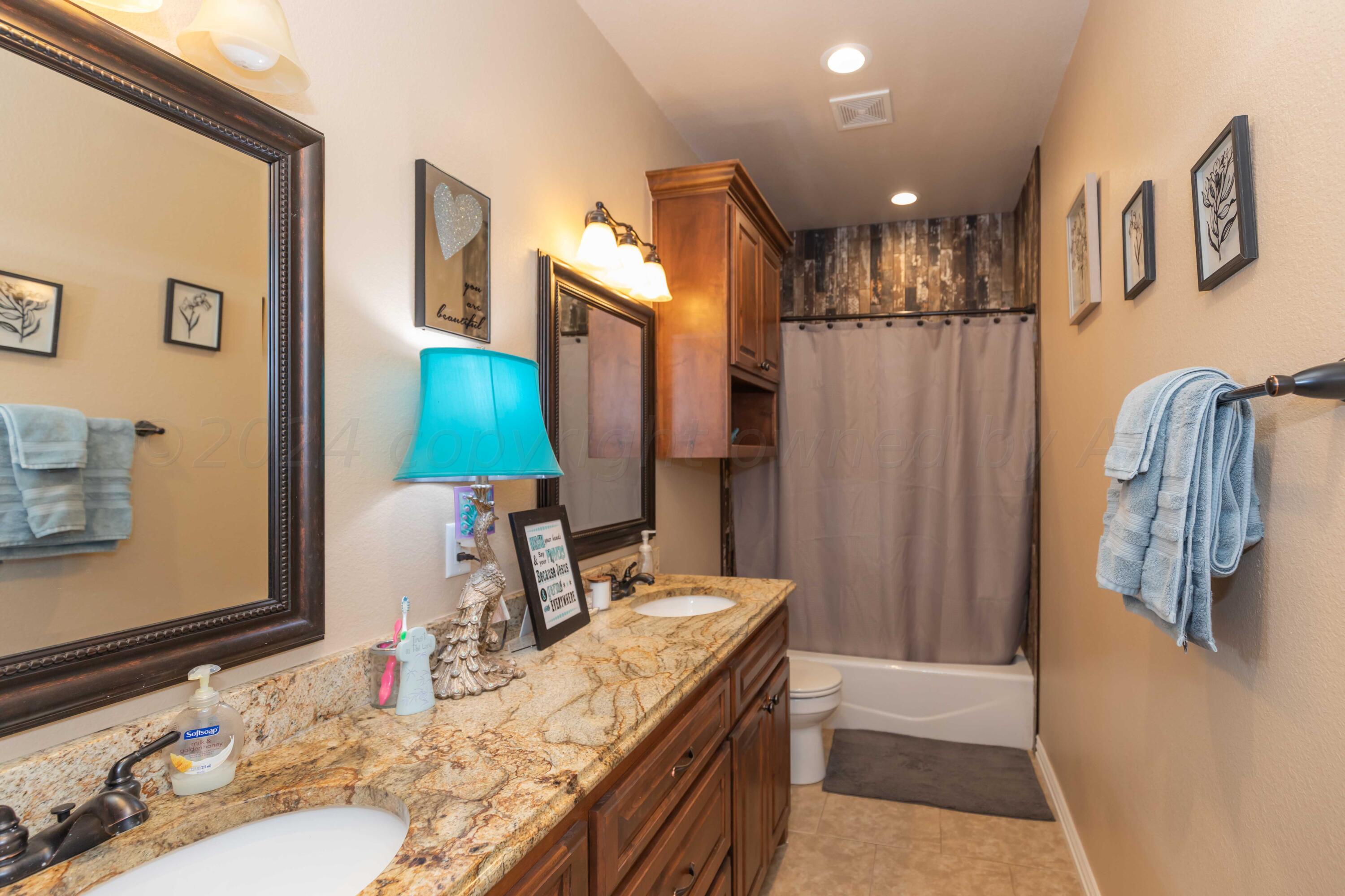 2450 Blue Springs Amarillo, TX 79124 - Photo 35 of 51 a bathroom with a sink vanity and a mirror