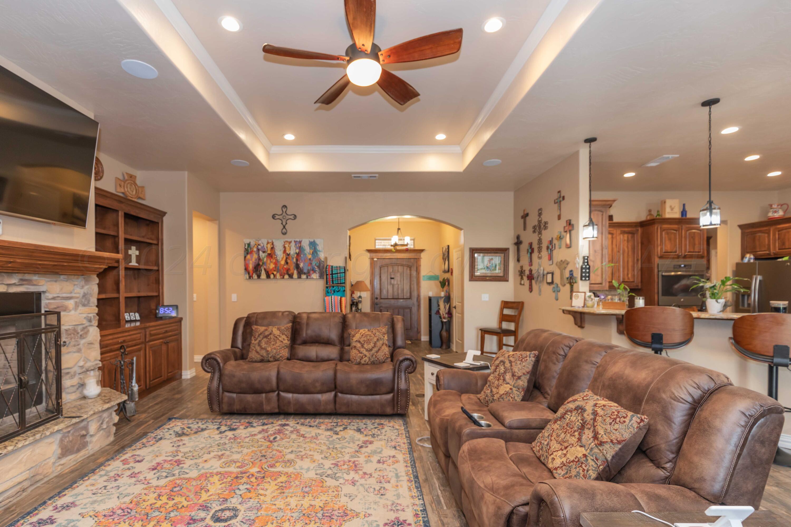 2450 Blue Springs Amarillo, TX 79124 - Photo 7 of 51 a living room with fireplace furniture and a chandelier