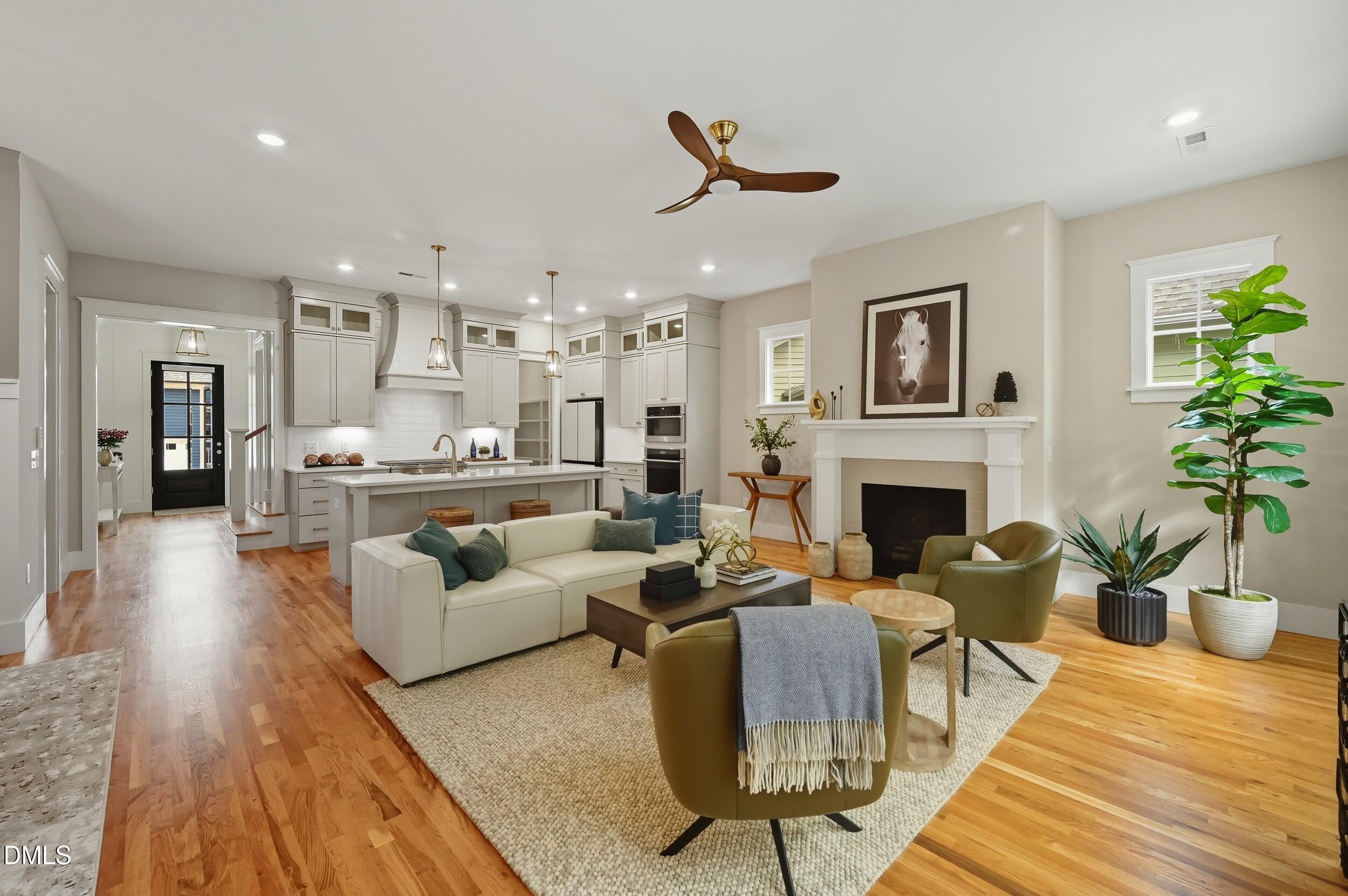 a living room with furniture a fireplace and a potted plant