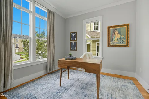 a view of a workspace with furniture and a window