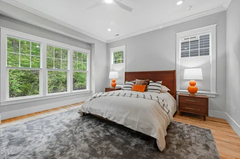 a bed sitting in a bedroom next to a window