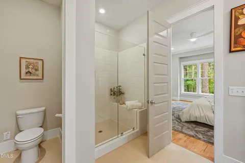 a bathroom with a granite countertop sink and a toilet