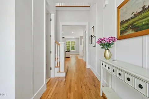 a view of a hallway with wooden floor