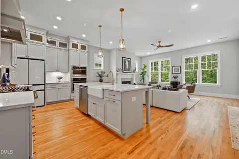a large kitchen with kitchen island a large counter top stainless steel appliances and cabinets