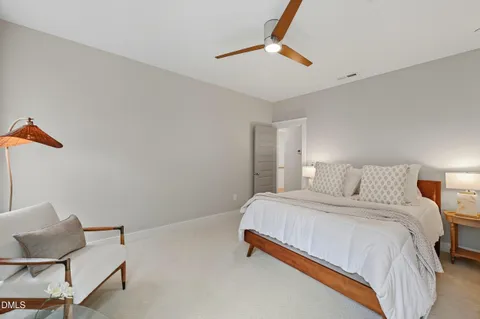 a bedroom with a bed and a chair