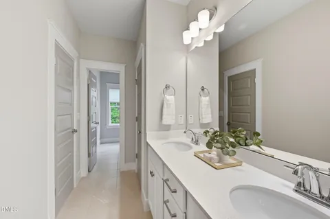 a bathroom with a sink vanity and a mirror