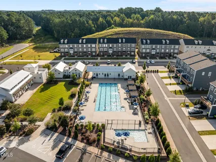 a view of swimming pool with outdoor seating and yard in back