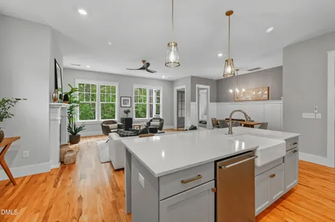 a large white kitchen with a large window