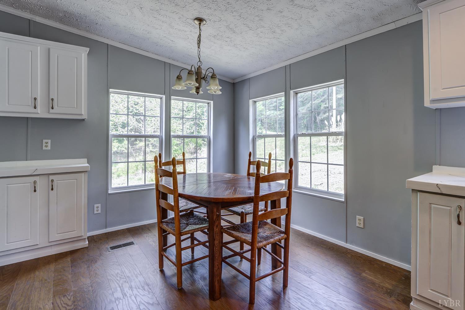 102 Slow Water Court Sandy Level, VA 24161 - Photo 20 of 66 a view of a dining room with furniture window and wooden floor