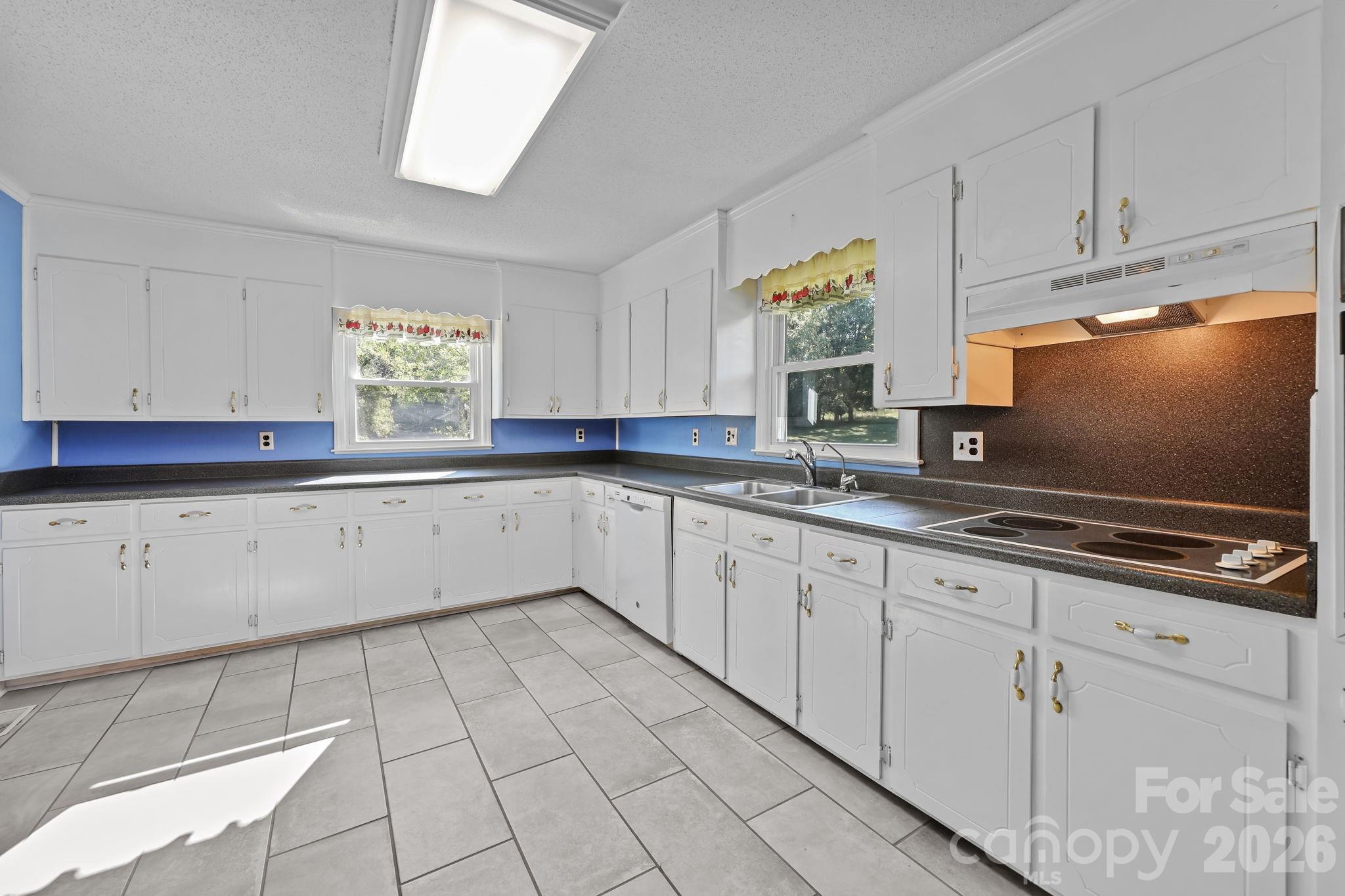 945 Alvin Hough Road Midland, NC 28107 - Photo 13 of 27 a kitchen with granite countertop a sink window and cabinets