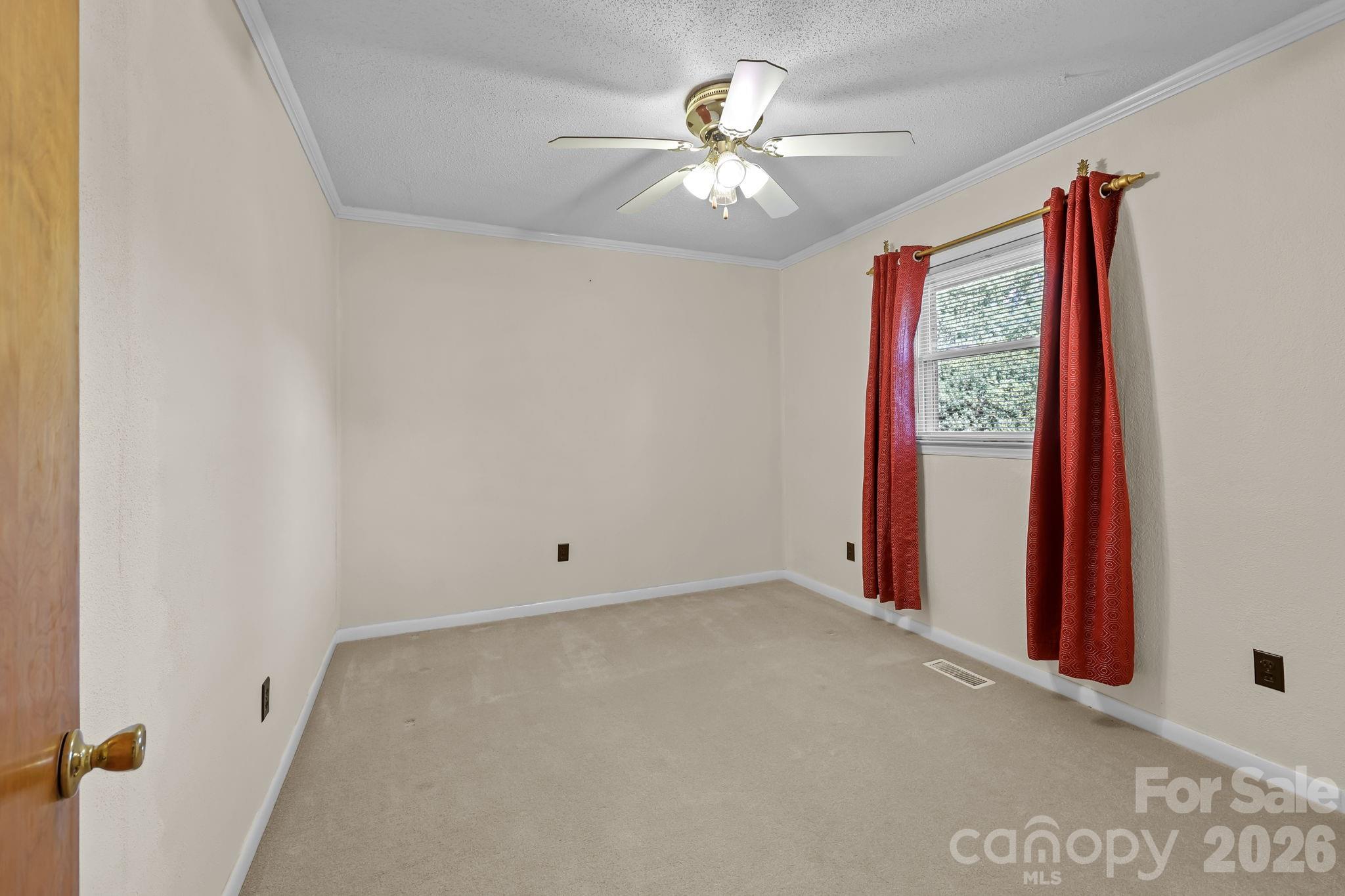 945 Alvin Hough Road Midland, NC 28107 - Photo 19 of 27 an empty room with windows and fan