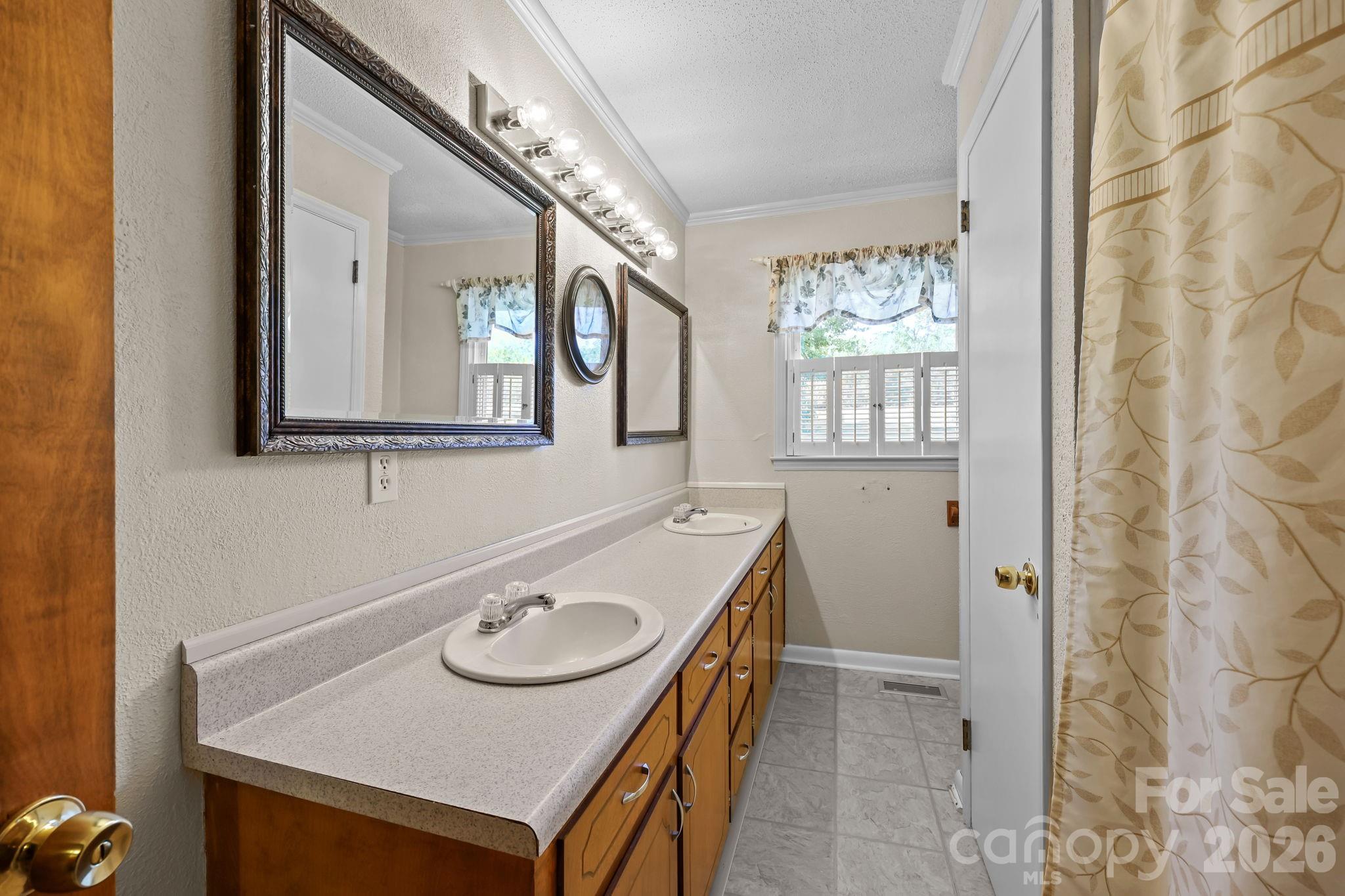 945 Alvin Hough Road Midland, NC 28107 - Photo 21 of 27 a bathroom with a sink a mirror and a window