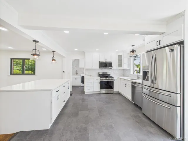 a kitchen with granite countertop cabinets and stainless steel appliances