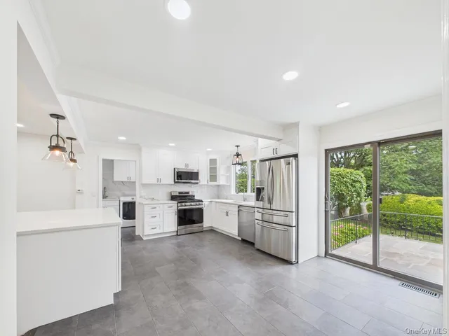 a kitchen with white cabinets and white appliances