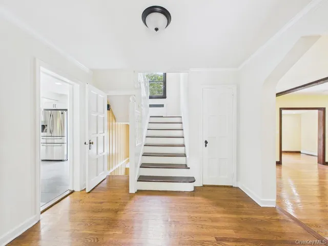 a view of a room with wooden floor and stairs