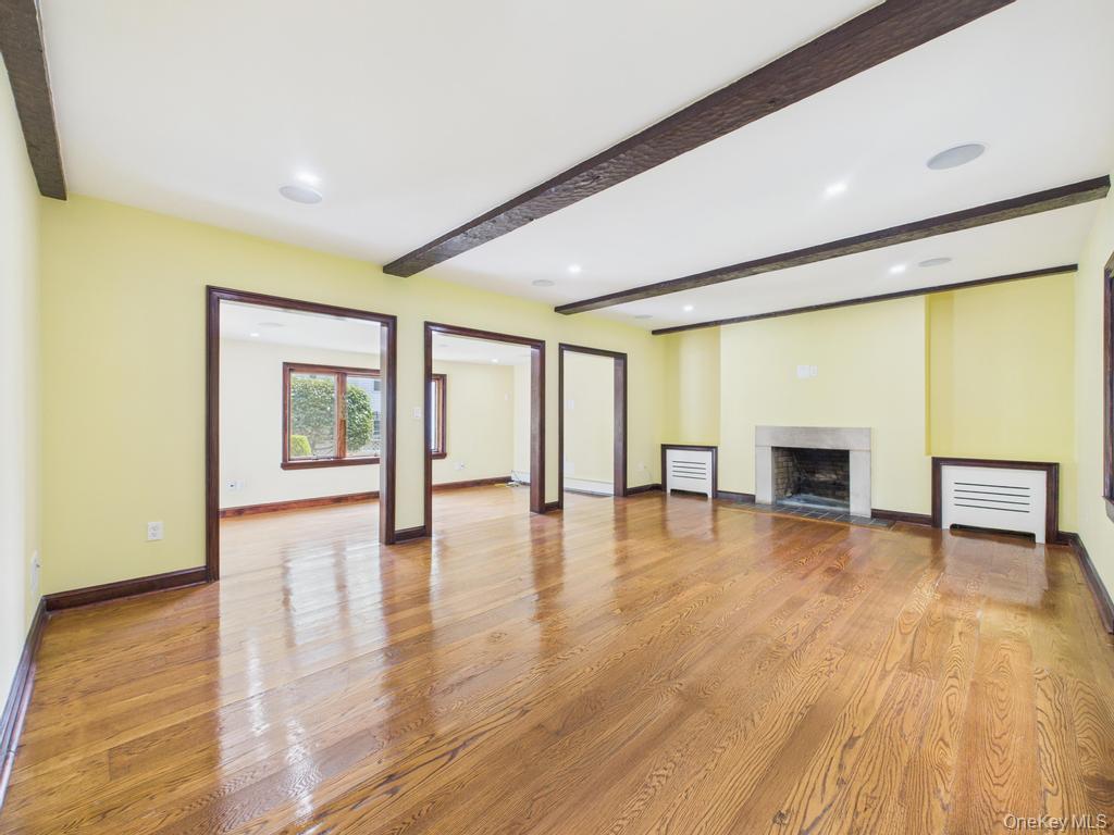 75 Lord Kitchener Road New Rochelle, NY 10804 - Photo 22 of 47 a view of empty room with wooden floor and fireplace