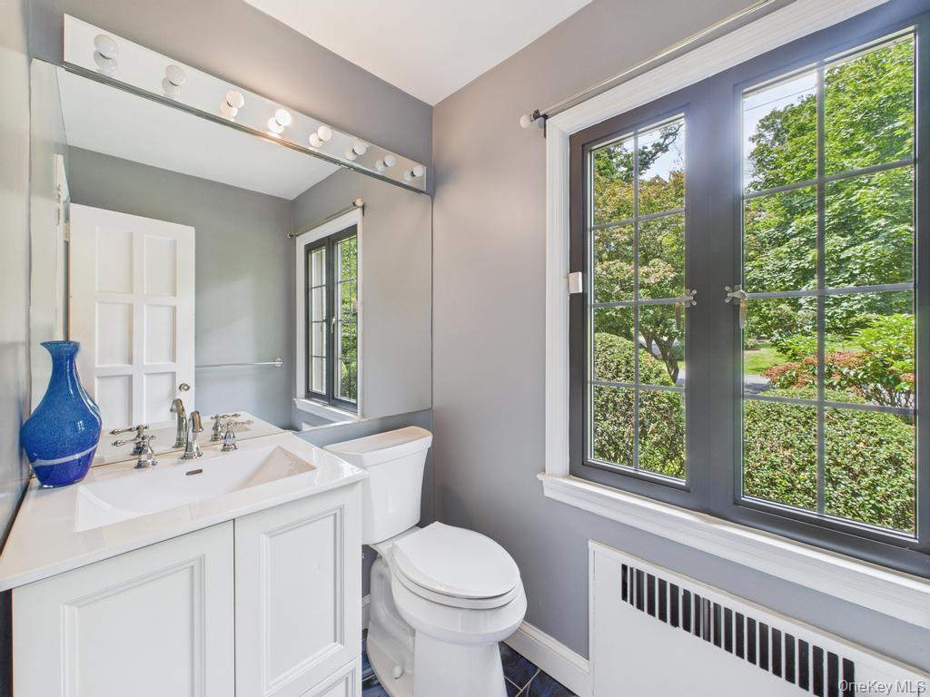 75 Lord Kitchener Road New Rochelle, NY 10804 - Photo 24 of 47 a bathroom with a toilet a sink and a window