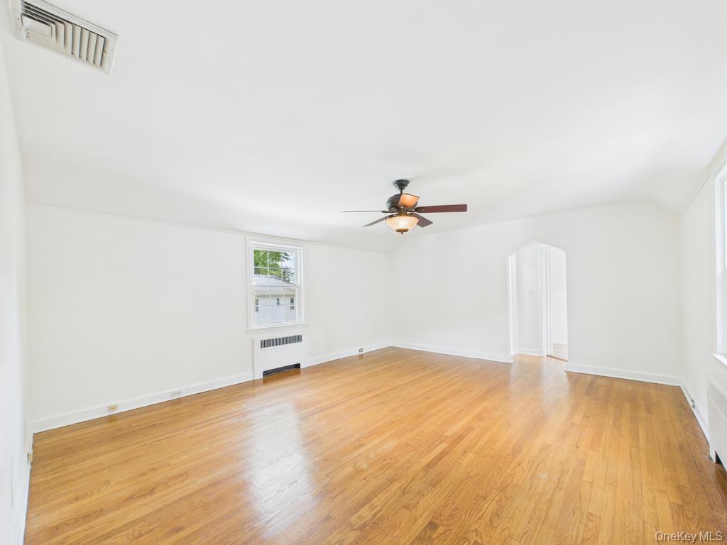 75 Lord Kitchener Road New Rochelle, NY 10804 - Photo 25 of 47 a view of empty room with wooden floor and fan