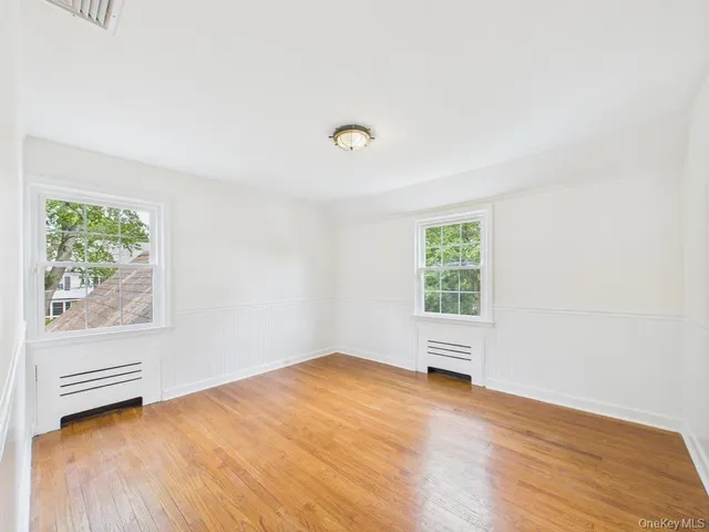 a view of room with window and hardwood floor