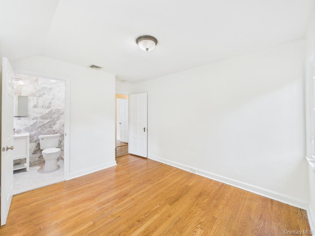 75 Lord Kitchener Road New Rochelle, NY 10804 - Photo 32 of 47 a bedroom with a bed and a white wall