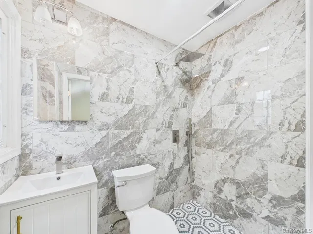 a bathroom with a toilet sink and shower