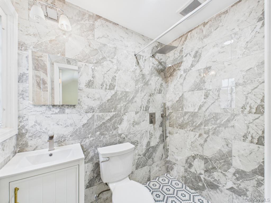 75 Lord Kitchener Road New Rochelle, NY 10804 - Photo 33 of 47 a bathroom with a toilet sink and shower