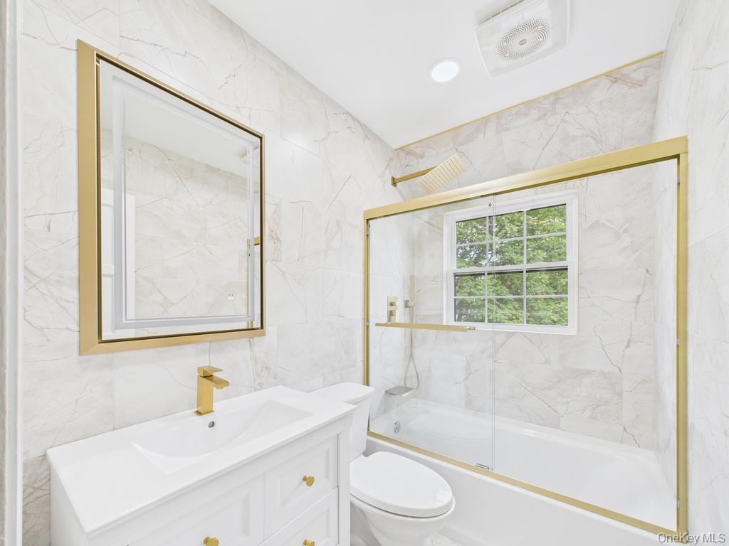 75 Lord Kitchener Road New Rochelle, NY 10804 - Photo 34 of 47 a bathroom with a sink mirror toilet and bathtub